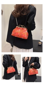 Detail of red Chinese style embroidery handbag with pearl strap and luxury floral pattern
