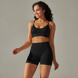 Detail of seamless black yoga set featuring V-neck sports bra and high-waist biker shorts