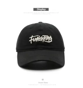 Close-up of a black cotton baseball cap featuring high-quality white 3D letter embroidery