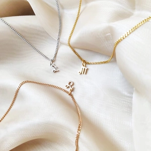 Stainless steel zodiac pendant necklaces in gold silver and rose gold on silk