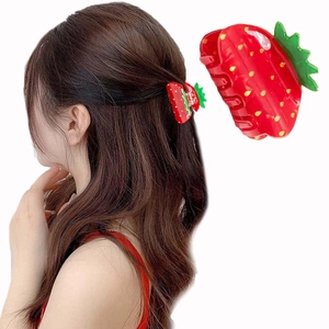 Close-up of red strawberry acrylic hair claw clip worn in a sweet ponytail hairstyle