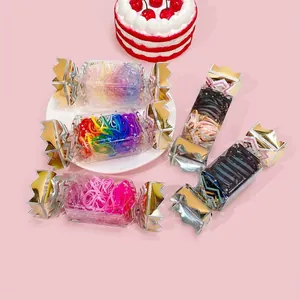 Close-up of colorful elastic hair bands in sweet candy-shaped gift box packaging