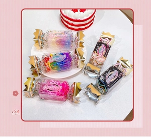 Close-up of colorful elastic hair bands in sweet candy-shaped gift box packaging