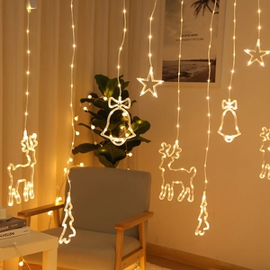 Warm white LED curtain lights with reindeer and star shapes for festive home decor