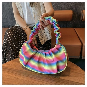 Detailed close-up of rainbow gradient pleated fabric and shoulder strap on hobo bag