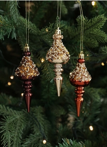 Detailed close-up of beaded Christmas teardrop ornaments with sequins on a festive tree