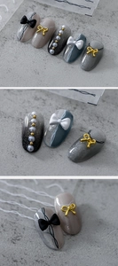 Détail de faux ongles dégradés avec nœuds en résine 3D, perles et accents métalliques