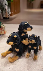 Realistic black and tan plush puppy in various poses including sitting and lying down