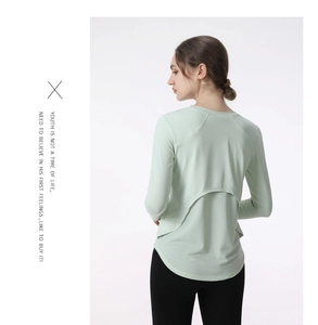Detail view of back layered design with breathable mesh on green long-sleeve yoga shirt
