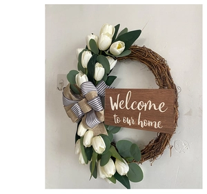 Close-up of artificial white tulips and wooden sign saying Welcome to our home