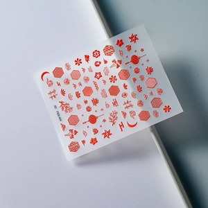 Macro shot of 5D stereoscopic Chinese wedding nail art stickers with red relief patterns