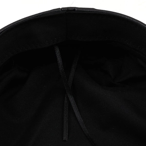 Close-up of black baker boy hat interior showing adjustable drawstring and sweatband