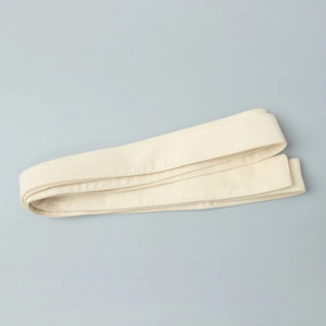 Detailed view of the creamy cotton waist belt showing the natural fabric texture