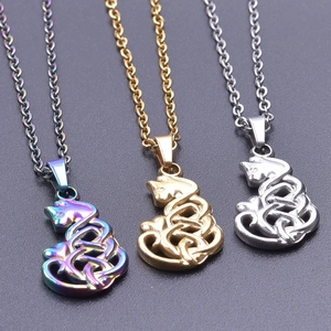 Macro shot of cat-shaped Celtic knot pendants in rainbow, gold, and silver finishes