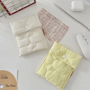 Quilted fabric tablet storage sleeve with snap button in cream and pale yellow colors