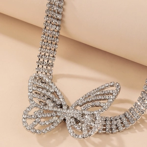 Macro close-up of crystal butterfly pendant and shimmering rhinestone choker necklace