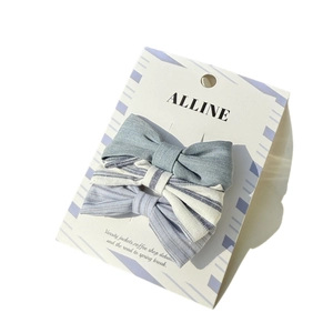 Three-piece blue and white striped bow hair clip set on a white display card
