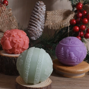 Detailed view of 3D embossed Christmas ball candles with Santa and bell patterns