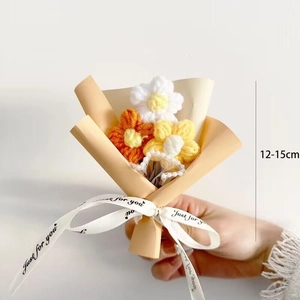 Detailed view of hand-knitted mini flower bouquet wrapped in beige paper with size scale