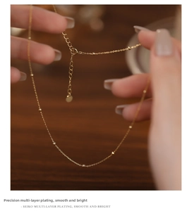 Close-up of golden S925 sterling silver bead chain necklace with adjustable clasp detail