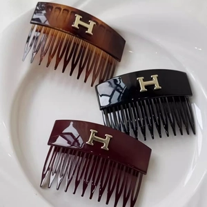 Three-piece acrylic hair comb set with gold H logo in tortoiseshell, black and red