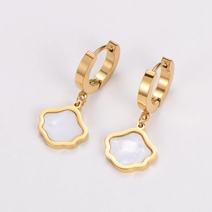 Detailed shot of gold hoop earrings with elegant white flower petal charms