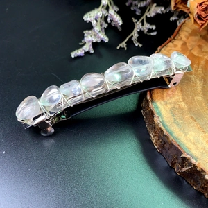 Macro detail of bohemian spring hair clip with clear crystal stones and silver wire wrap