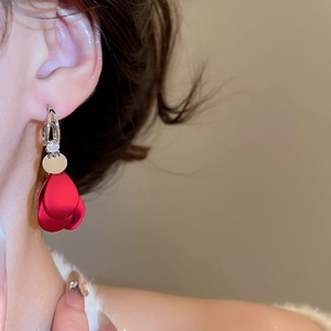 Detail of red velvet flower earrings with zircon drop on model for a vintage look