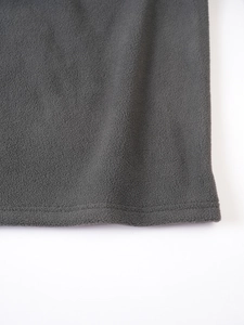 Close-up of charcoal fleece fabric showing premium stitching and soft warm texture