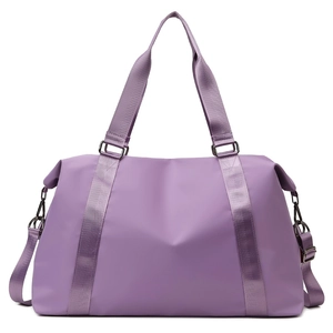 Macro shot of purple waterproof nylon gym bag featuring adjustable strap and metal hardware