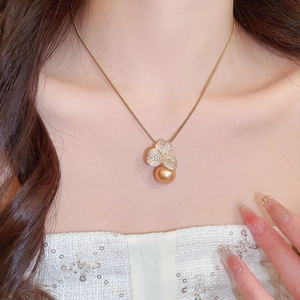 Detailed close-up of a gold pearl pendant featuring zircon flower petals on a snake chain
