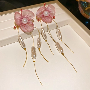 Detail view of pink chiffon flower earrings with long gold tassel and baroque pearls