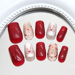 Cat eye press-on nails set with red bows and colorful glitter in medium-long square shape