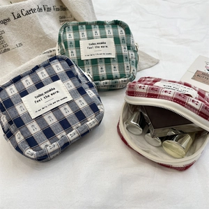 Detailed view of checkered cotton organizer bags with cherry patterns and top zipper closure