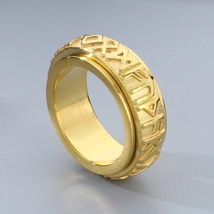 Gold Viking rune spinning ring in polished stainless steel shown from 45-degree angle