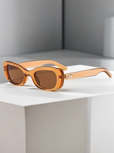 Macro view of retro amber oval sunglasses featuring tortoiseshell texture and brown lenses