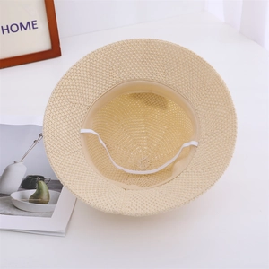 Detail of beige woven straw hat with sweatband and elastic chin strap for children