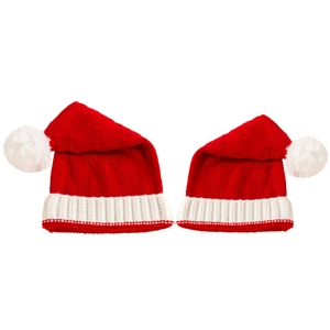 Detailed knit texture of red Christmas beanies with fluffy white pom-poms on top