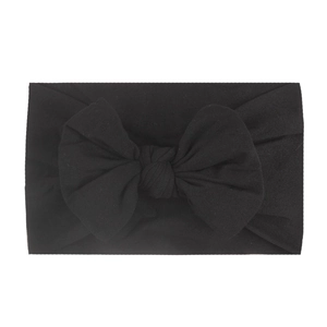 Soft black nylon baby headband with a large handmade bow decoration for infants
