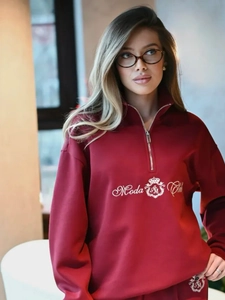 Detail of the high-quality gold Moda Club embroidery on the burgundy sweatshirt fabric
