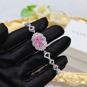 Detailed macro view of a silver bracelet featuring a pink oval gemstone with fine zircons