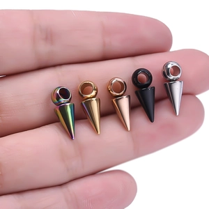 Macro shot of 5 cone-shaped stainless steel pendants in multiple colors on fingers