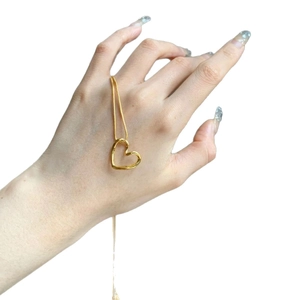 Minimalist gold twisted heart pendant necklace on a sleek stainless steel chain