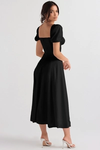Detail of elegant black French midi dress featuring chic square neckline and puff sleeves