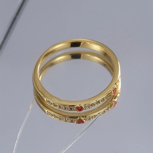 Minimalist gold-plated copper ring with red enamel heart and sparkling zircon details