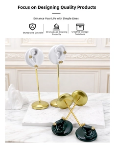 Detail view of ear-shaped resin jewelry holder with gold metal rod and luxury finish