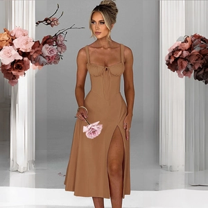 Detail of caramel silk corset dress featuring lace-up bodice and high side slit design