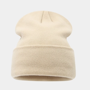 Detail of beige fine knit beanie showing high-elasticity texture and folded wide brim edge