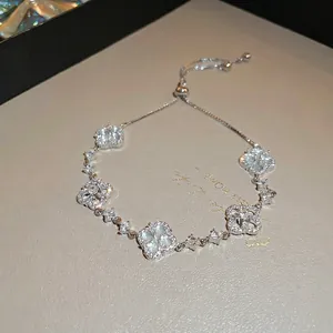 Silver flower bracelet with white mother-of-pearl charms and sparkling zircon crystals
