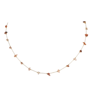 Detail of bohemian gold chain necklace with natural brown and orange crushed stone beads